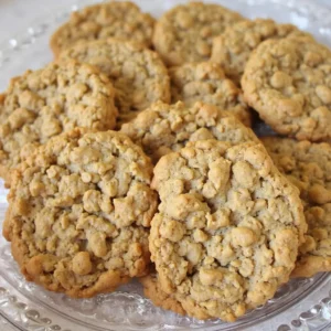 quaker oatmeal cookie recipe 3 A plate full of classic, golden-brown Quaker oatmeal cookies with a textured surface.