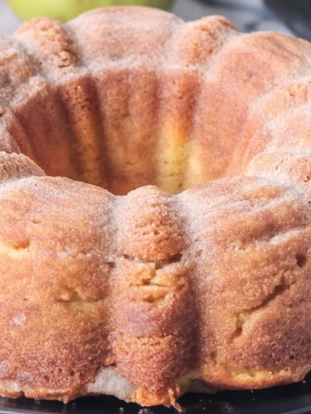 Moist Apple Cider Donut Cake topped with cinnamon sugar, perfect for fall treats.