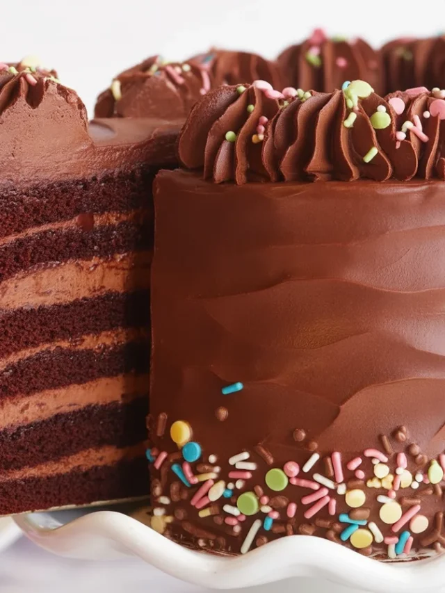 Decorated chocolate cake with artistic frosting and toppings.