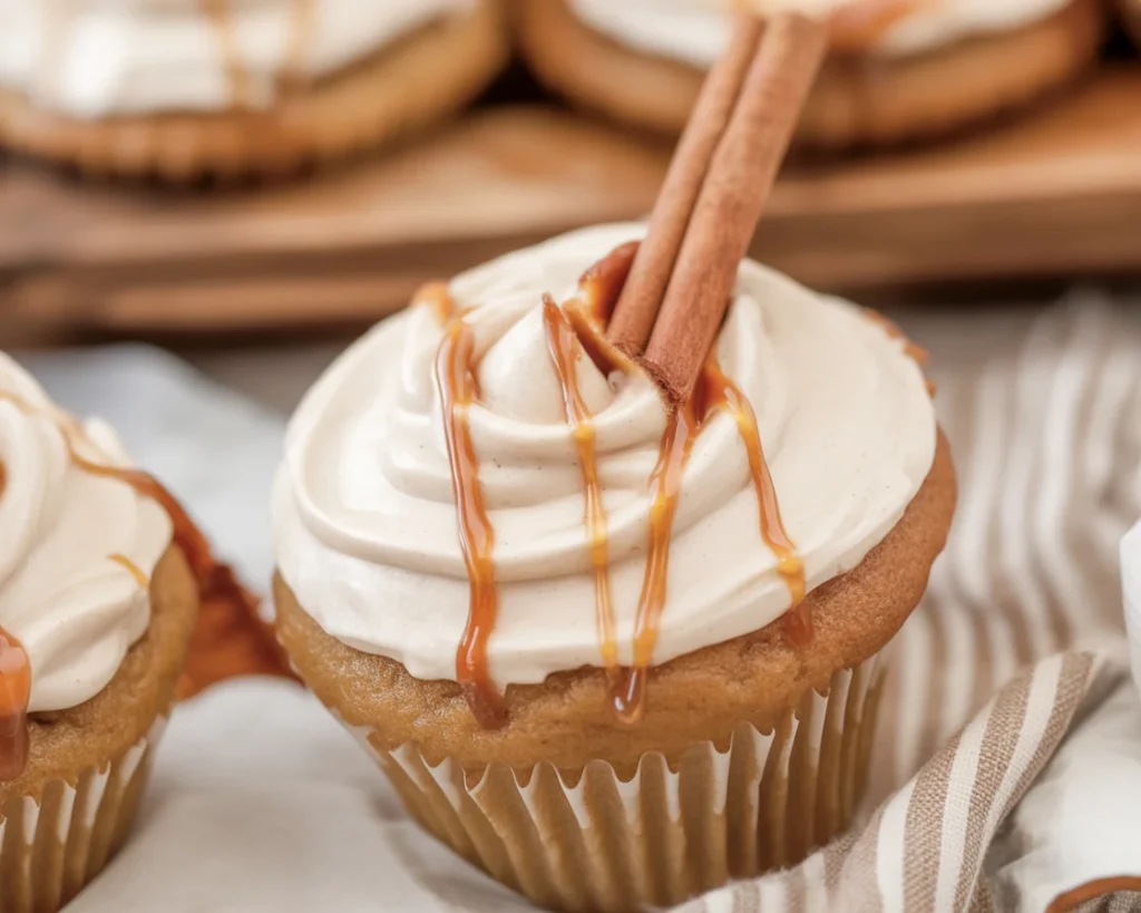 Moist apple cider cupcakes topped with spiced buttercream and fall decorations.