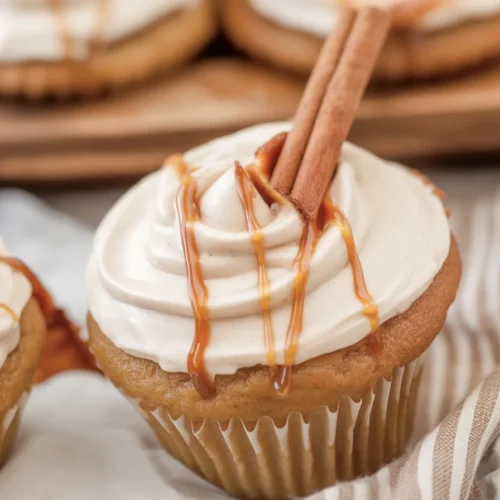 Moist apple cider cupcakes topped with spiced buttercream and fall decorations.