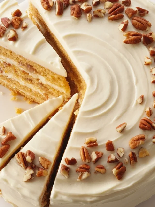 A beautifully decorated fall themed birthday cake with autumn leaves and floral accents.