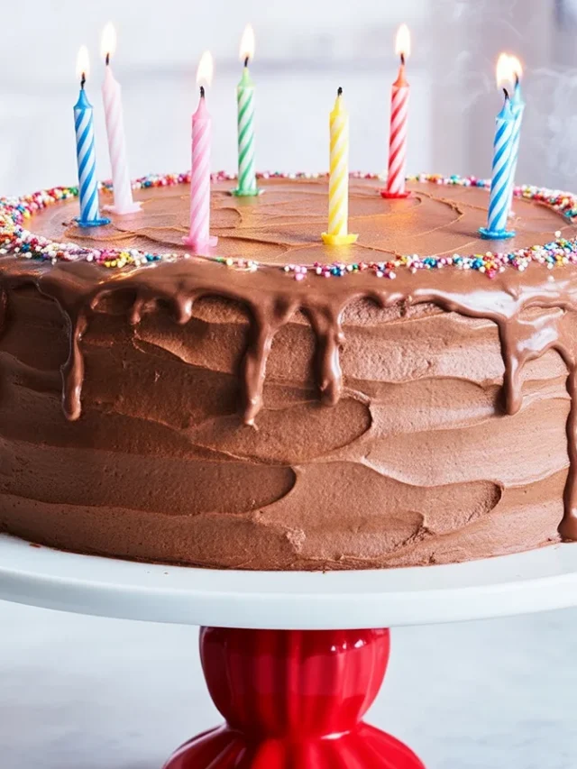 A stunning unique birthday cake adorned with colorful decorations and fresh fruits.