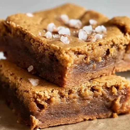 Blondie Brownies 2 Deliciously chewy homemade Blondie Brownies on a wooden table
