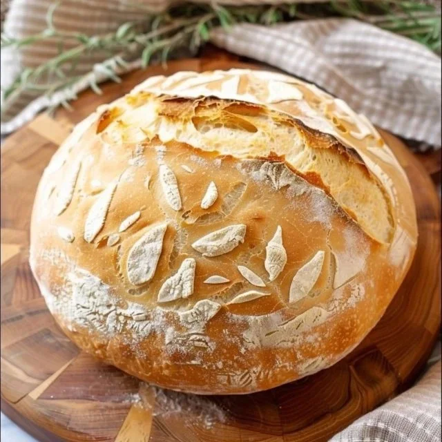 Freshly baked sourdough bread loaf on a wooden table