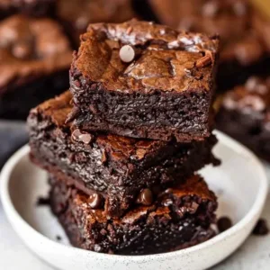 Bowl of healthy fudgy gluten free brownies topped with chocolate drizzle