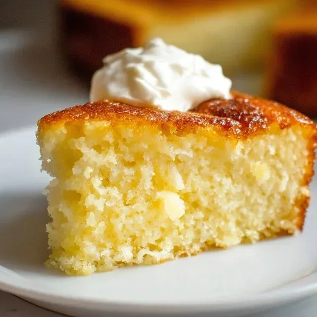 Healthy Greek Yogurt Cake with fresh fruit topping on a white plate.