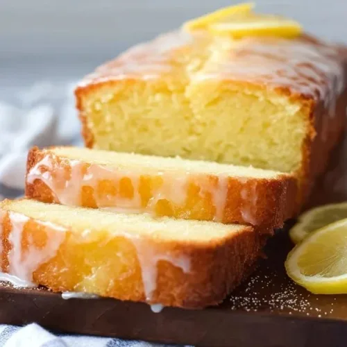 Moist lemon pound cake with a golden crust and lemon zest garnish