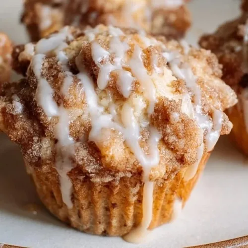 Quick Easy Sourdough Discard Coffee Cake Muffins 2 Freshly baked sourdough discard coffee cake muffins on a platter.