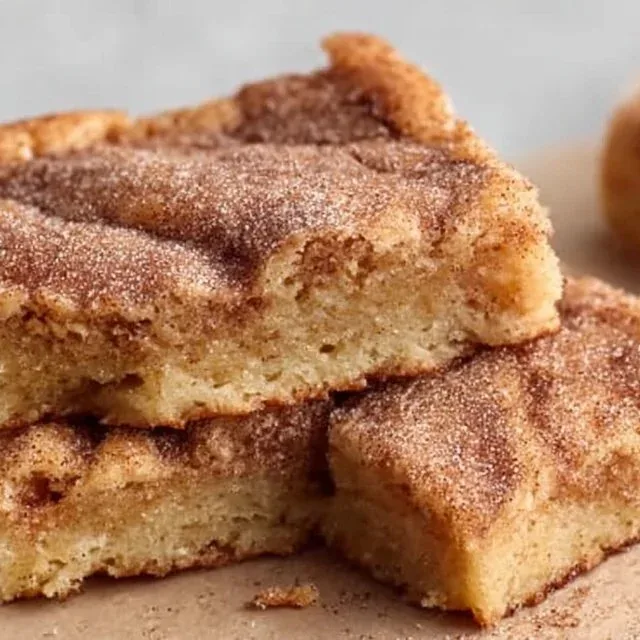 Plate of snickerdoodle blondies topped with cinnamon sugar