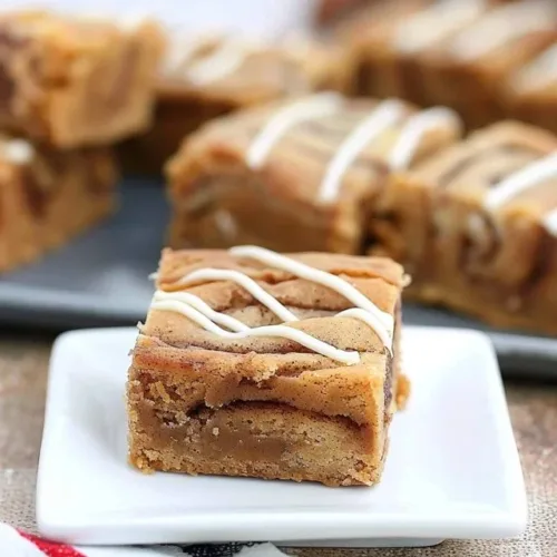 Delicious soft cinnamon roll blondies topped with creamy frosting