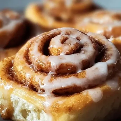 Freshly baked sourdough cinnamon rolls topped with icing