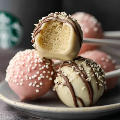 Starbucks Cake Pop easy Recipe 2 Homemade Starbucks cake pops on a table, colorful and delicious.