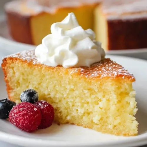 Delicious slice of Greek yogurt cake topped with fresh berries