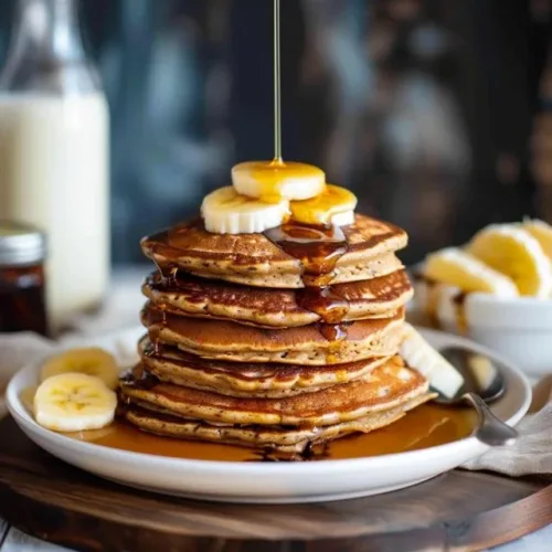Fluffy 3 Ingredient Sourdough Pancakes on a plate with syrup
