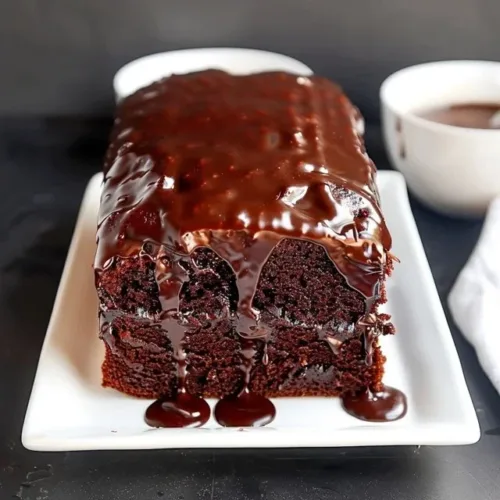 Delicious chocolate pound cake with sour cream, topped with chocolate icing.