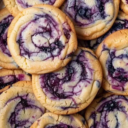 Freshly baked easy blueberry cheesecake cookies on a cooling rack