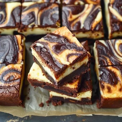 Gluten free chocolate cheesecake brownies topped with chocolate drizzle