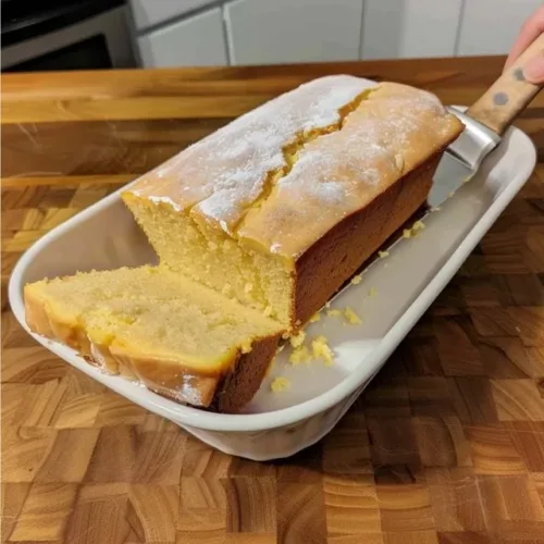 Grandma's low-point loaf cake served on a rustic wooden table.