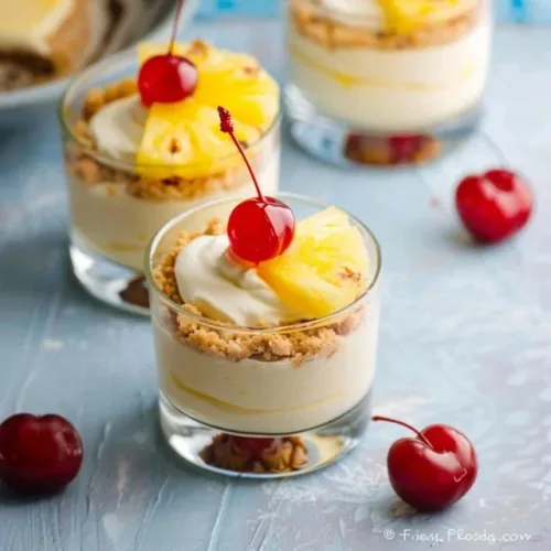 Hawaiian pineapple cheesecake cups with crushed pineapple and cream cheese topping