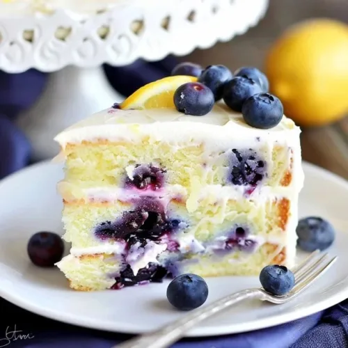 Sliced Lemon Blueberry Cake with fresh blueberries on top