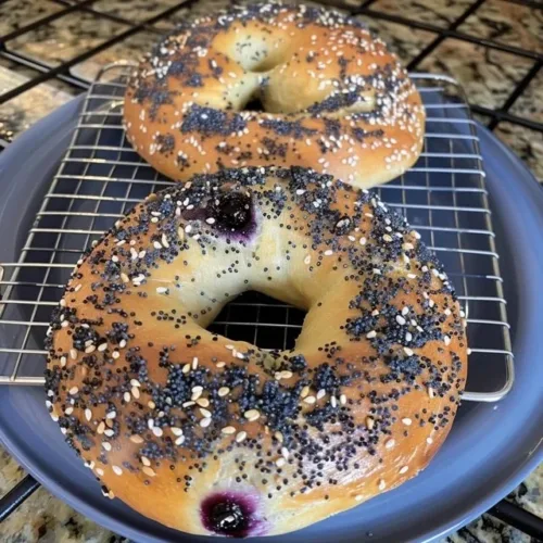Freshly baked sourdough blueberry bagels on a wooden table