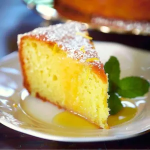 Sunny Lemon Sour Cream Pound Cake with fresh lemon slices on top