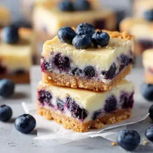 Deliciously creamy Blueberry Cheesecake Bars with fresh blueberries on top