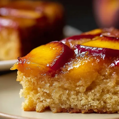 Delicious moist peach cake topped with slices of fresh peaches