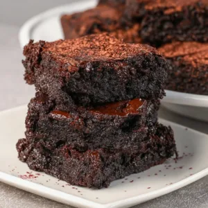 Delicious quick sourdough brownies on a plate with chocolate drizzle