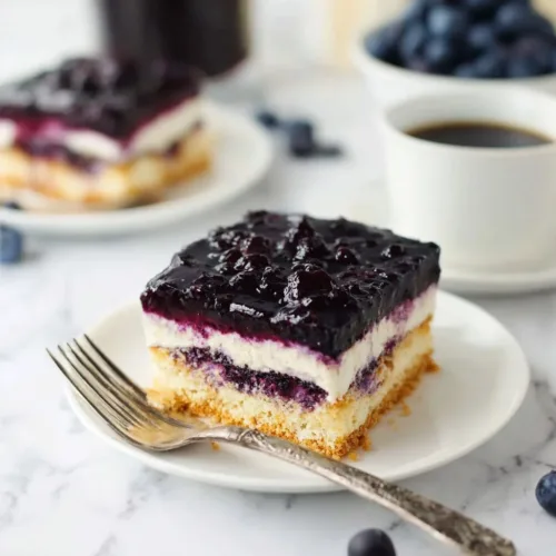 Delicious Blueberry Icebox Cake topped with fresh blueberries and cream