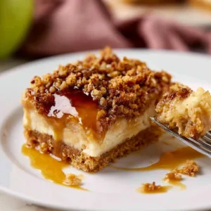 Delicious caramel apple cheesecake bars topped with caramel drizzle
