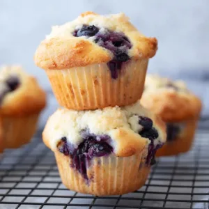 Cottage cheese blueberry muffins fresh out of the oven on a baking tray.