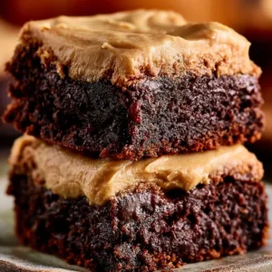 Delicious frosted coffee brownies with chocolate glaze on a plate