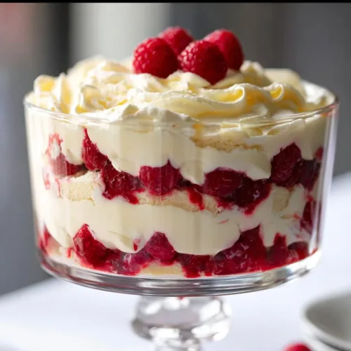 Delicious white chocolate raspberry trifle dessert with whipped cream and fresh raspberries