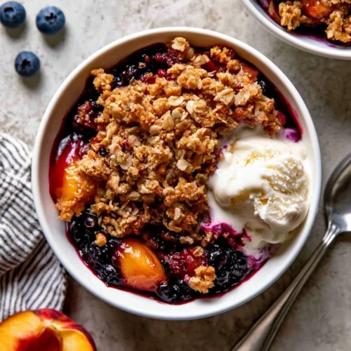 Homemade blueberry peach crumble with a golden brown topping