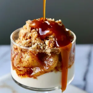 Caramel apple cheesecake cups garnished with caramel drizzle and apple slices