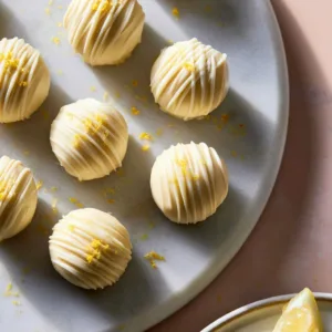 Delicious homemade lemon truffles garnished with lemon zest.