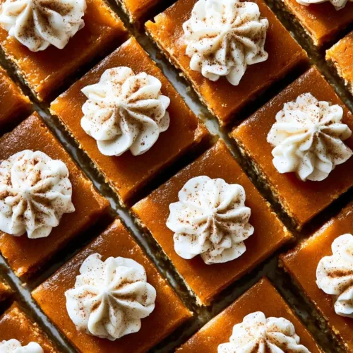 Delicious easy pumpkin pie bars topped with whipped cream on a white plate.