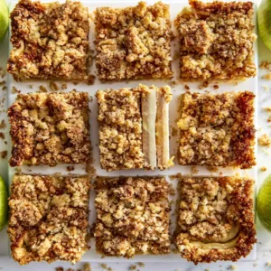 Homemade Apple Shortbread Bars 2 Delicious homemade apple shortbread bars on a wooden table